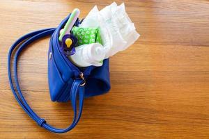 Women's handbag with items to care for the child photo