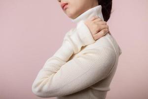 Asian young woman hold her hand on pain neck and injury ache shoulder stress problem muscle. Office syndrome disease, healthcare concept photo