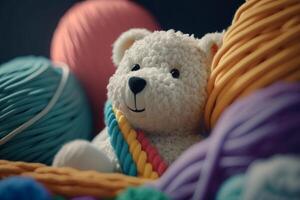 white knitted bear in balls of thread photo