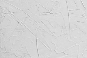 white abstract background of paste filler and bonding plaster with irregular dashes and strokes photo