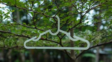 a hanger hanging on tree photo