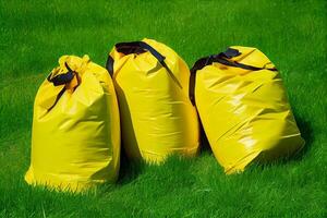 yellow garbage bags on the grass illustration photo