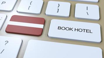 Book hotel in Latvia with website online. Button on computer keyboard. Travel concept 3D animation. Book hotel text and national flag. 3D illustration photo