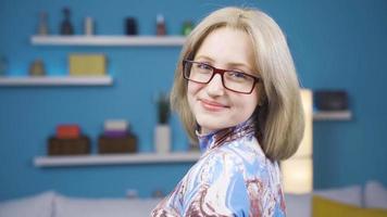 Young blonde woman smiling at camera. Positive image. Attractive cute woman taking off her glasses looking at camera and smiling. video