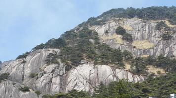 The beautiful mountains landscapes with the green forest and the erupted rock cliff as background in the countryside of the China photo