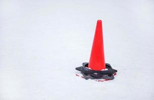 traffic cone at a sidewalk on snow photo