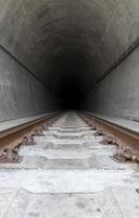 Train tunnel running through mountain photo