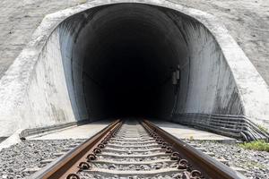 Train tunnel running through mountain photo