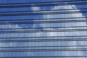 windows of modern building with reflection of clouds photo