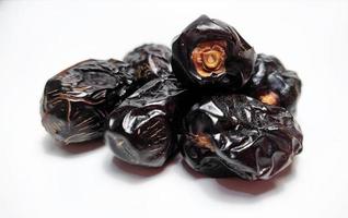 Close up of dried ajwa dates fruit isolated on white background photo