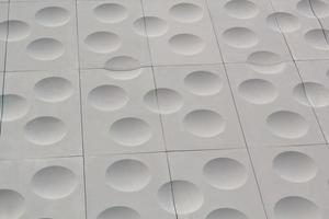 The close-up of grey detailed sphere texture reverse side of the plastic tile. Rough embossed lattice. Concept of design. Wall decoration interior. Relief balls geometric pattern. Flatlay, mock up photo