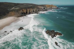 drone view of beach with waves and turquoise water photo