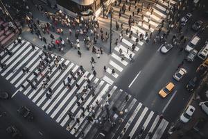 Aerial. People crowd on pedestrian crosswalk. Top view background. Toned image photo