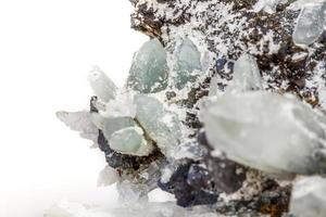 Macro mineral stone Drusus quartz with sphalerite in the rock a white background photo