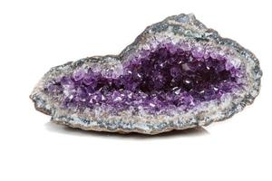 Macro Mineral Stone Amethysts in the rock on a white background photo