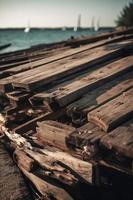 antiguo de madera muelle en el playa a puesta de sol. selectivo atención foto