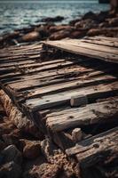 antiguo de madera muelle en el playa a puesta de sol. selectivo atención foto