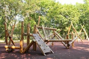Wooden modern ecological safety children outdoor playground equipment in public park. Nature architecture construction playhouse in city. Children rest and childhood concept. Idea for games on air. photo