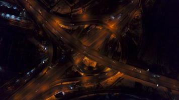 Vertical top down aerial view of traffic on freeway interchange at night video