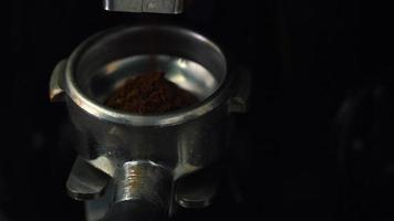 Process of grinding coffee beans in a coffee machine closeup video