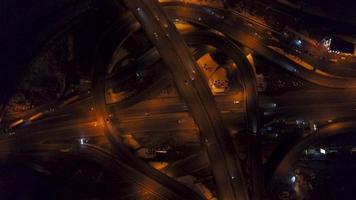 Vertical top down aerial view of traffic on freeway interchange at night video