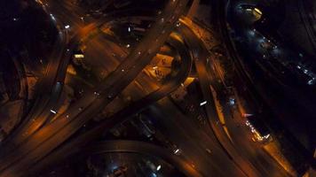 Vertical top down aerial view of traffic on freeway interchange at night video