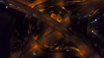 Vertical top down aerial view of traffic on freeway interchange at night video