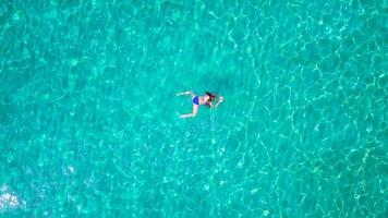 Relaxed beautiful girl lies on her back in the summer sea video