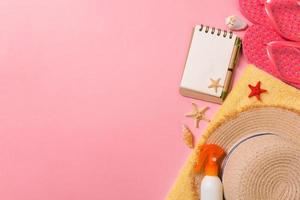 Flat lay, top view Travel concept. summer accessories with note paper and seashell on pink background photo