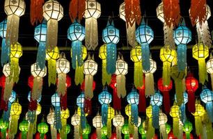 colorful hanging lanterns lighting on night sky in loy krathong festival at northern of thailand photo