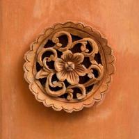Circle flower carved on wood background for decoration, Traditional Thai style pattern photo