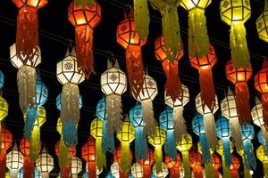 colorful hanging lanterns lighting on night sky in loy krathong festival at northern of thailand photo