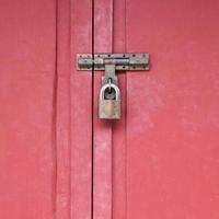 red wood gate with lock, locked wooden doors photo