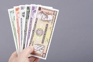 Old Peruvian money in the hand on a gray background photo