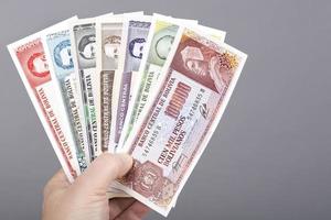 Old Bolivian money in the hand on a gray background photo