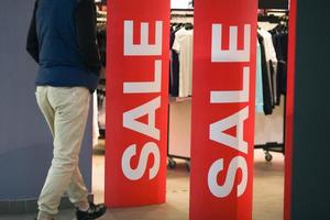 Sale signs on in a store. Concept of shopping, sales, discounts. Seasonal discount offer in store. Discounts and black friday concept. photo