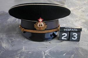 Wooden calendar with the date of February 23, and  headgear officer of the Navy of the USSR and Russia Defender of the Fatherland Day. Men day in Russia. photo