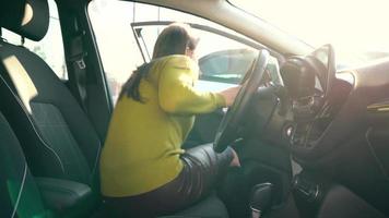 Woman sits in the car and the seat belt before driving video