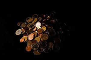 Coins on a black background photo