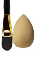 Cosmetic brush and face sponge vertically on a white background. Means for applying cosmetics. photo