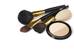 Loose powder, various makeup brushes. Makeup artist accessories isolated on white background. Products for perfect facial skin makeup. photo