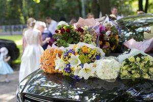 Flowers on a wedding car. Wedding day. photo