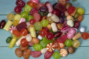 Many sweets. Multi-colored caramel on a wooden board. Sweets. photo