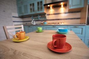 Tea cups on the table against the background of the kitchen. photo