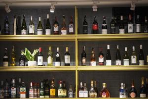 Belarus, the city of Gomil, February 08, 2020. Showcase wine shop. Many bottles of wine stand on a shelf. photo