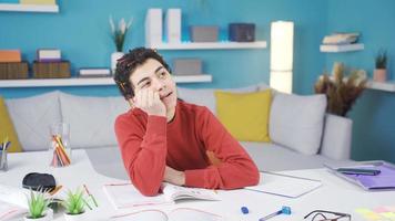 The fun boy who is immersed in daydreaming. Lazy child dreams happy instead of studying at the desk. video