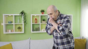 Elderly man with congested heart or having heart attack falls ill at home. The old man, fainting and struggling to breathe, is heartbroken and depressed. video