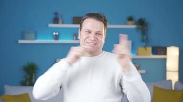 Fun man at home dancing, having fun, happy and cute alone. Enthusiastic dancing adult man having fun at home, being happy like a child. video