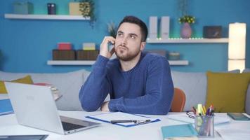 Man working from home is working his job excitedly. The man working from home is excitedly waiting for news and is working on his job excitedly. video