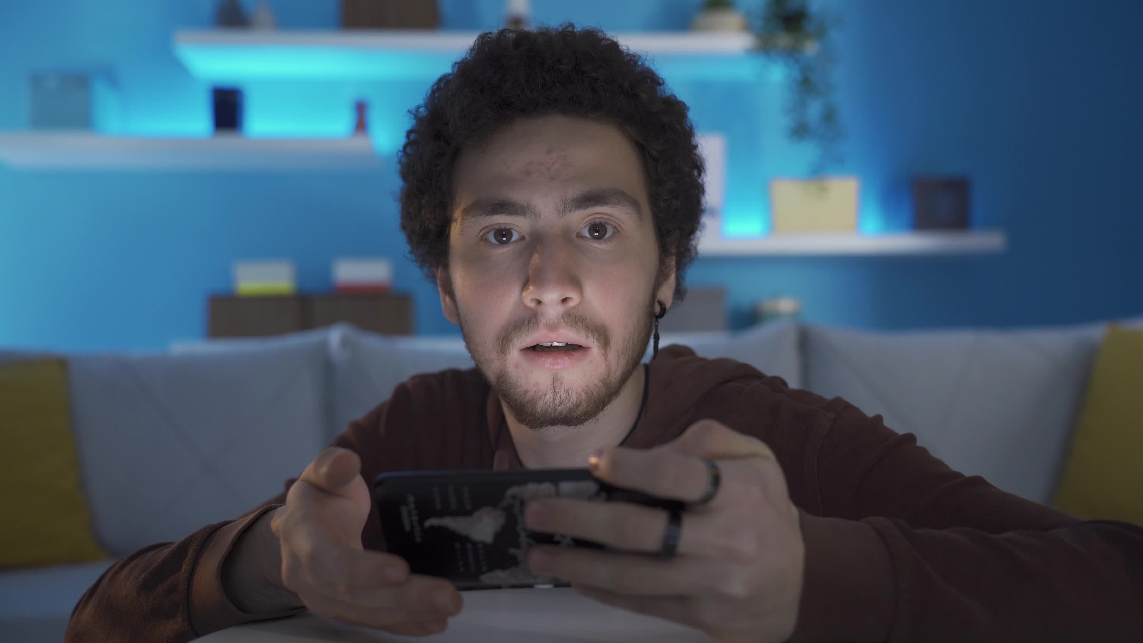 Gamer young man playing mobile game on his smart mobile phone. Mobile